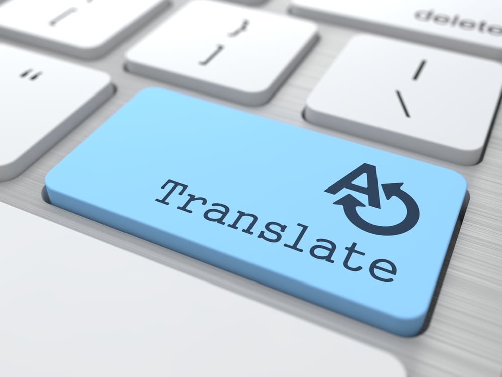 Blue translate button on a keyboard highlighting the significance of using humans for document translation