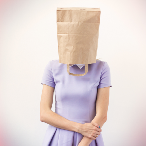 Woman with paper bag over her head feeling awkward about her language training