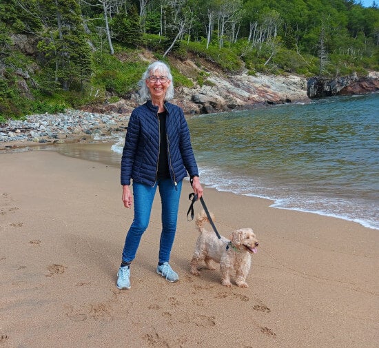 Female language instructor walking dog on a beach