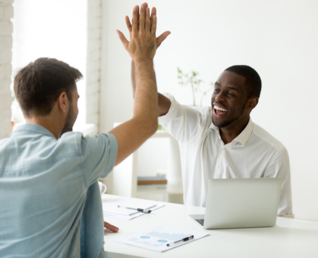 Two men giving a high five after a great language training session
